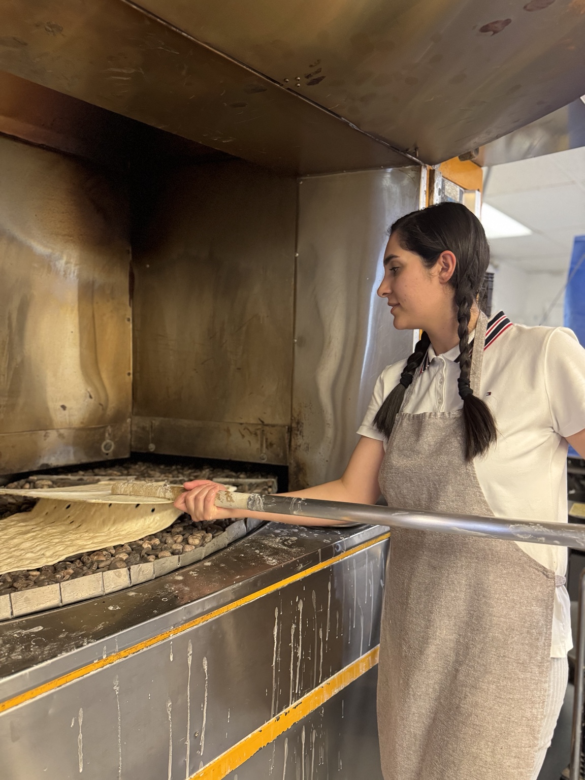 Sara baking Sangak directly on hot stones