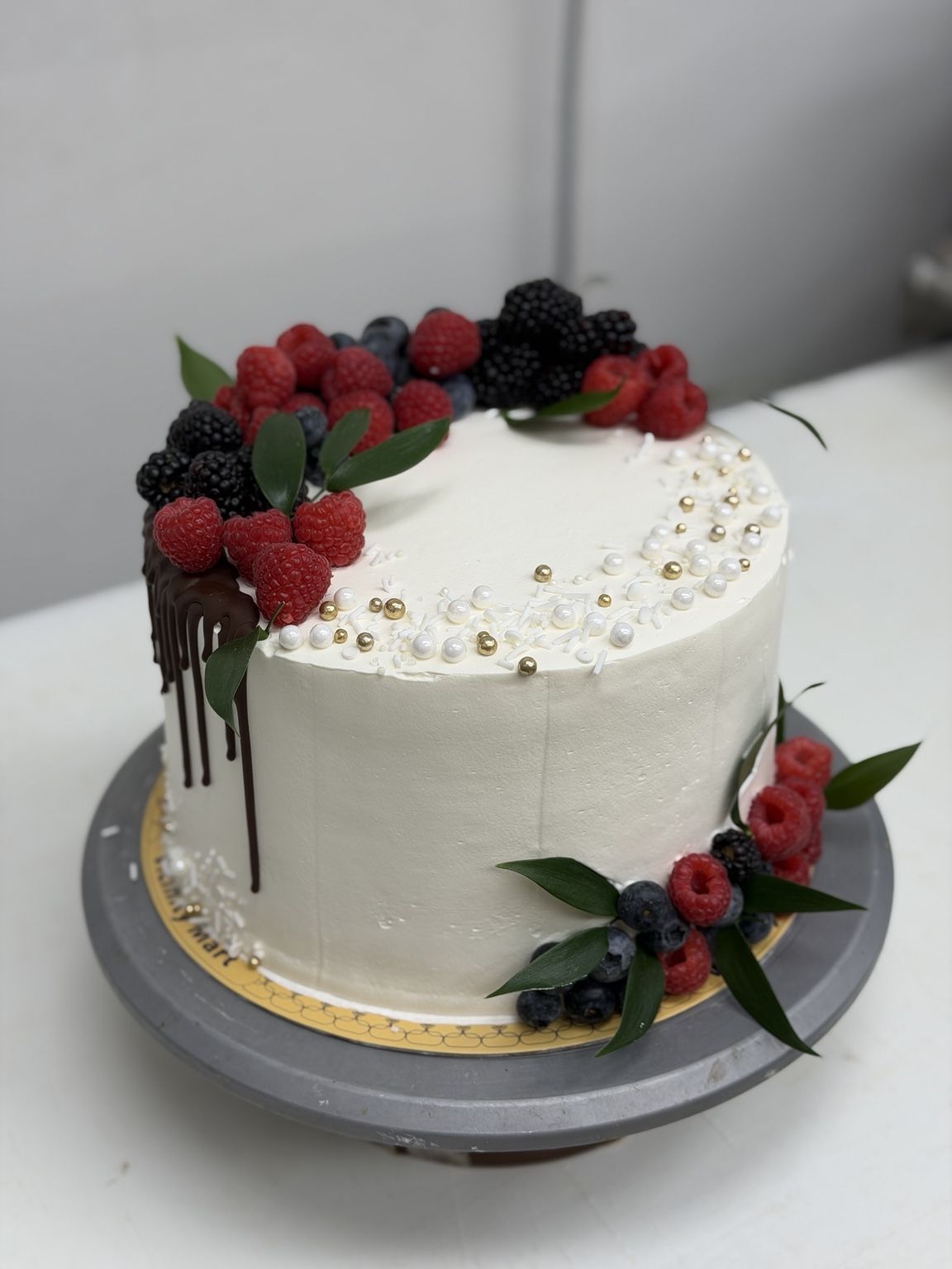 Custom celebration cake decorated with berries